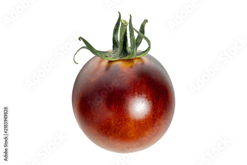 Fotografie Ripe black tomato fruit with glossy surface and green calyx