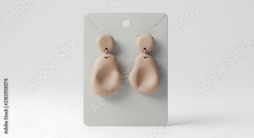 Minimalist peach-colored dangle earrings mockup, blank spaces for text