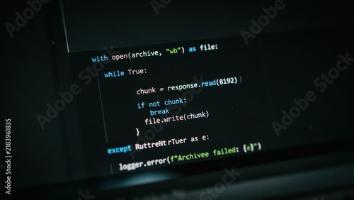 Plakat w ramie Python programming code displayed on a computer screen showing a file download script with error handling and logging functions in dark mode