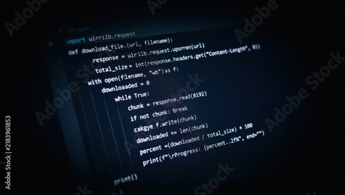 Obraz na płótnie Python programming code displayed on a dark computer screen showing a file download function with syntax highlighting and indentation structure