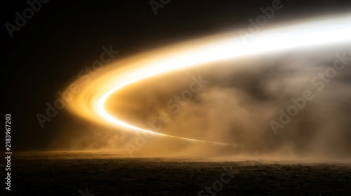Fiery golden light arc with dense smoky haze on dark textured ground, abstract energy background