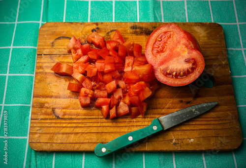 Top View Diced Red Tomatoes and Half Tomato on Wooden Board