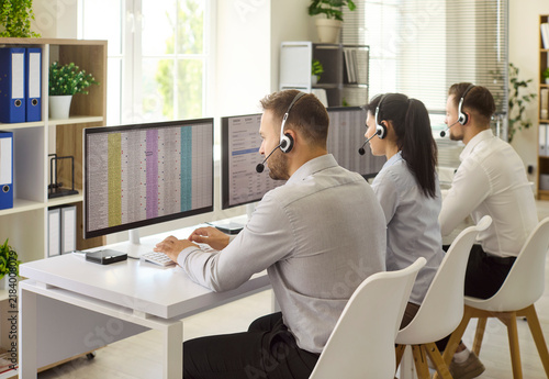 Photography Callcenter agents with headsets support customers daily