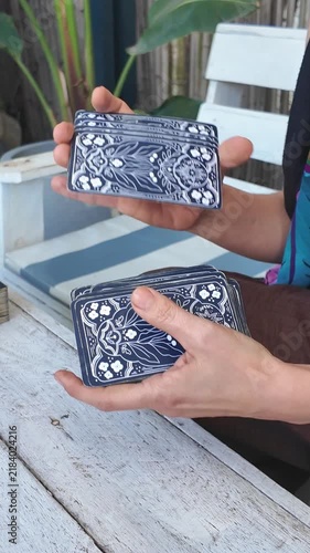 Close up of woman hands shuffling a tarot deck on a wooden table