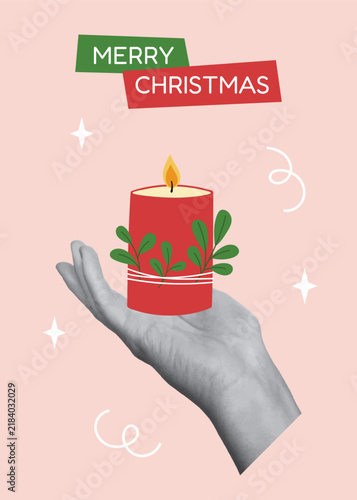 Christmas greeting card template. Hand holding burning red Christmas candle with green leaves on pastel pink background