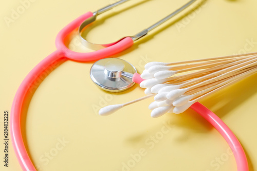 wood swabs or Cotton swabs with stethoscope on background.