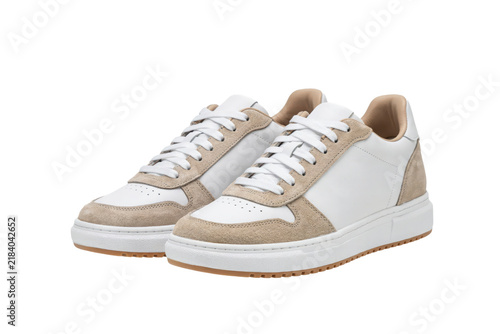 Pair of white leather sneakers with beige suede accents and white laces isolated on a transparent background