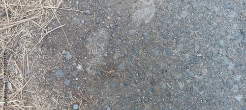 Coarse dirt and crushed stone ground border bordered by dry straw grass, ideal for outdoor trail backdrops, natural terrain overlays, and eco-themed layout graphics