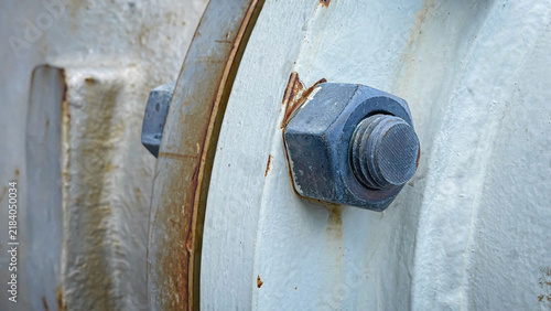 Fotografie Close up of stud bolt and nut connect two pipe flanges in an industrial plant, s