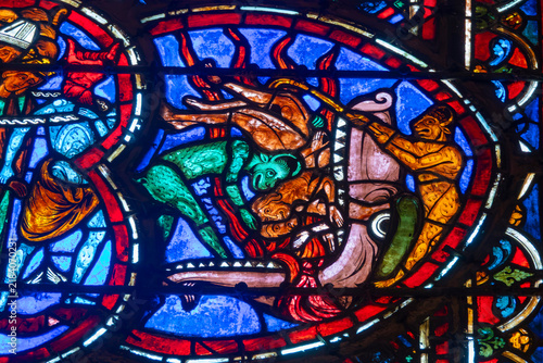 Konstfotografi A medieval stained glass window depicts demons pushing damned human souls into a monster mouth