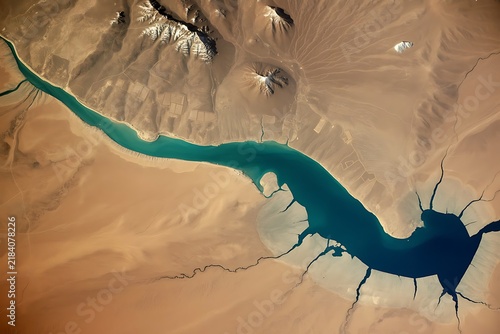 River winds through a barren desert landscape from high altitude.