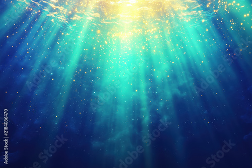 Underwater sunlight rays beaming through deep blue water with bokeh particles.