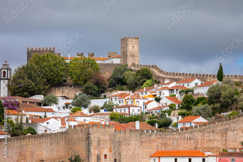 Panoramic cityscape of Obidos showing historic fortifications, white houses, and terracotta roofs - Portugal