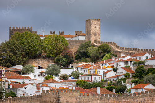 Panoramic cityscape of Obidos showing historic fortifications, white houses, and terracotta roofs - Portugal