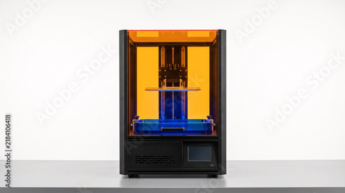 Obraz na płótnie 3D printer with orange enclosure and blue light printing object