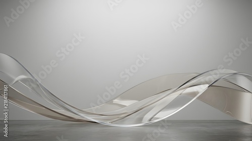 Abstract silver wave background with flowing metallic ribbons on grey studio surface