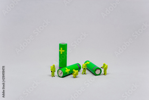 Scientists inspecting green batteries. Green energy concept