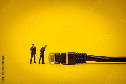Miniature Business people with internet network cable. Technology concept