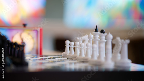 Obraz na plátně Close-up of chess pieces with shallow depth of field and vivid abstract bokeh, s