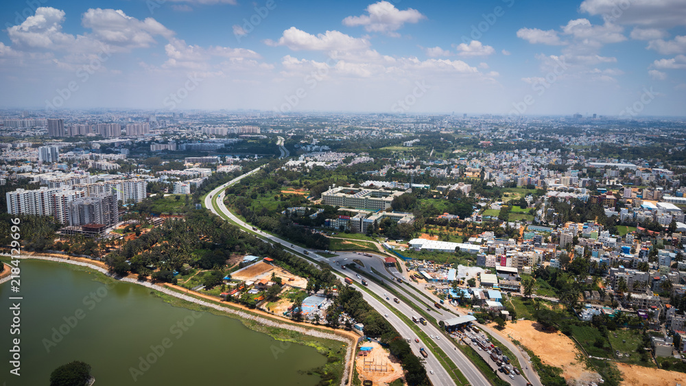 Fototapeta premium Urban lake and road network in Bangalore viewed from above