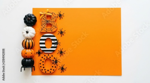 Halloween decoration with stacked pumpkins, boo letters, and spiders isolated on white background