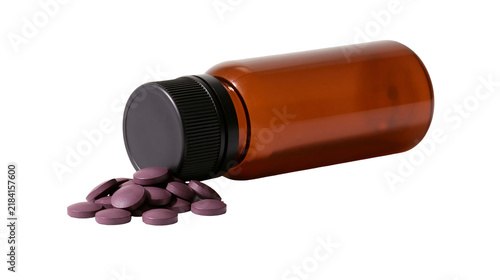 Plakat Isolated brown opaque plastic medicine bottle with black cap and spilled purple pills