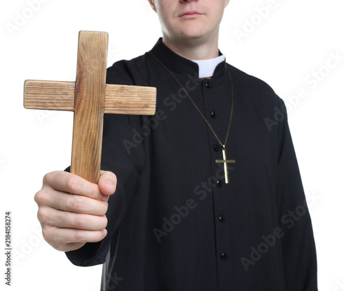 Photography Priest in cassock with wooden cross on white background, closeup
