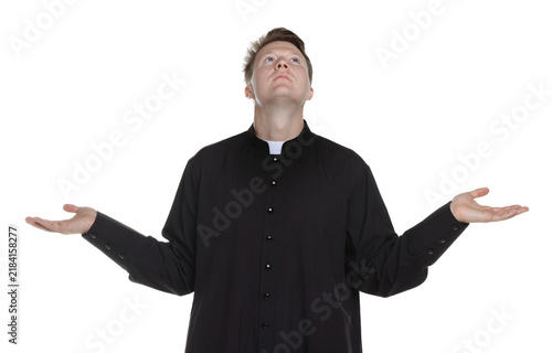 Foto Priest in cassock praying on white background