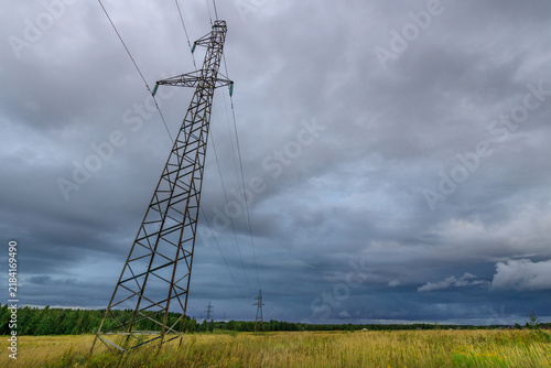 Konstfotografi Powerful pylon silhouetted in dramatic sky above grassy plain