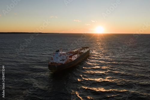 Obraz na płótnie Aerial drone view of a large oil tanker in Tallinn Bay during a windy sunset with choppy waves