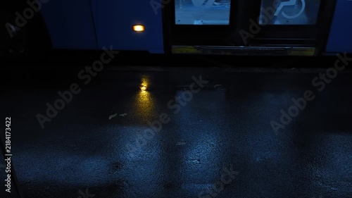 Public city bus arriving at a bus stop on a rainy day, opening doors for passengers and continuing its route, showing urban transportation, daily commuting and public transit lifestyle