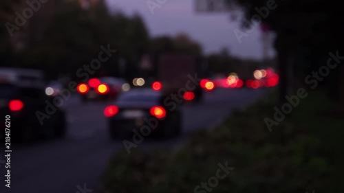 Defocused urban traffic scene with glowing vehicle lights and soft bokeh at dusk, creating a versatile abstract background for advertising, media projects, presentations and modern visual design