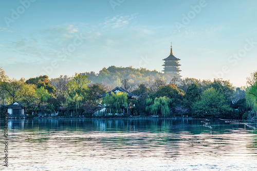 Obraz na plátně Leifeng Pagoda rises above West Lake in Hangzhou, surrounded by traditional gardens and willows on a peaceful clear morning