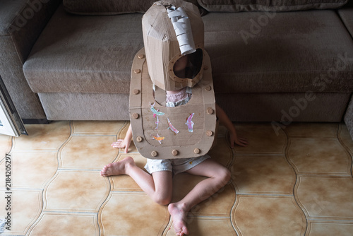 Bild auf Leinwand Child Wearing a Homemade Cardboard Costume Indoors