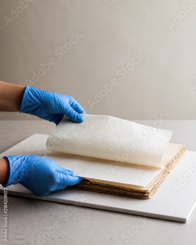 Museum Collection Disaster Recovery - gloved hands interleave damp paper with blotters