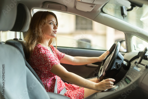 Принти на полотні Young woman sitting in car driving, she took driving courses in the city