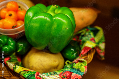 Fresh vegetables arranged in a basket at a local market during the morning hours