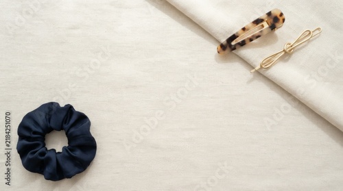 Minimalist Hair Accessories and Navy Scrunchie on Linen Fabric