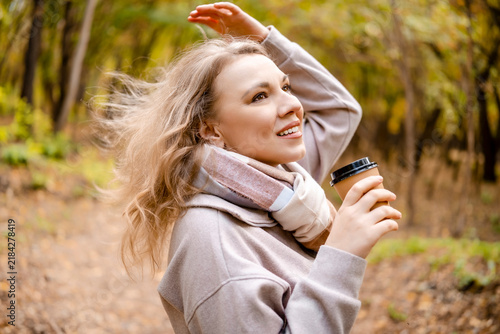 Konstfotografi Carefree woman in autumn forest with cup — true harmony with nature