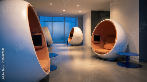 Futuristic Pod Chairs with Orange Cushions in a Modern Lounge