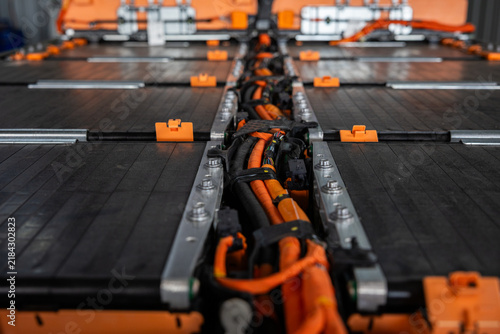 Фотография Battery module and orange cable assembly inside EV garage with industrial energy