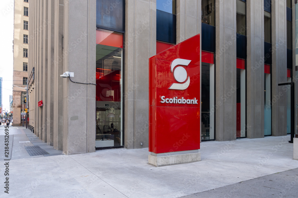 Obraz premium Toronto, Ontario, Canada - September 7, 2026: A red outdoor ground sign and logo for Scotiabank, one of Canada's major financial institutions, located outside a branch in downtown Toronto, Ontario, Ca