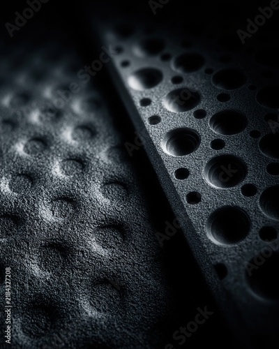Black rubber perforated texture dot pattern material close up