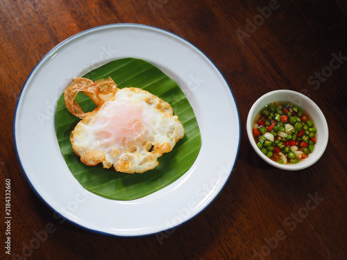A fried duck egg sits on the plate; it looks appetizing and wonderfully crispy.