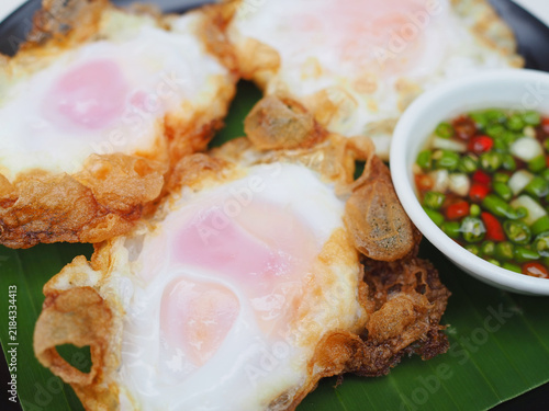 Obraz na płótnie Several fried duck eggs are arranged on a plate; they look appetizing and wonderfully crispy