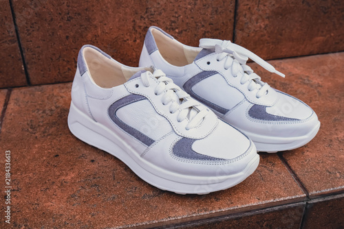 Konstfotografi Fresh white leather sneakers without brand marks displayed