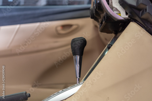 Canvastavla Close up of an automatic gear shift lever handbrake inside beige car interior da