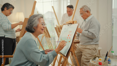 Принти на полотні Senior Asian group participating in art therapy painting class at a nursing home