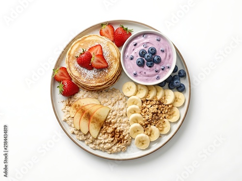 Morning breakfast plate with pancakes, oatmeal, berry yogurt and banana slices