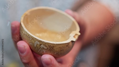 Person pouring traditional mexican mezcal drink